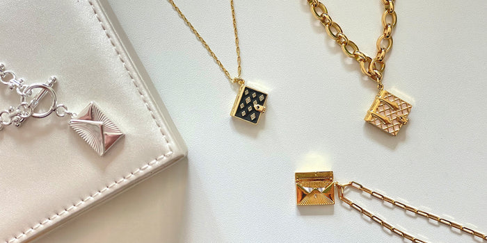 Gold and Silver Love Letter Envelope Lockets along with a onyx Stardust Book Locket and pearl Secret Diary Book Locket bracelet